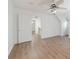 Light filled bedroom with wood floors, ceiling fan, and a doorway with access to the stairway at 3775 Belle Glade Trl, Snellville, GA 30039