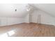 An open attic bonus room has hardwood floors, white walls, and a ceiling fan at 3775 Belle Glade Trl, Snellville, GA 30039