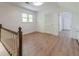 Bright bonus room with wood floors, a window, and white trim at 3775 Belle Glade Trl, Snellville, GA 30039