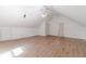 Vaulted bonus room with light wood floors, a fan, and multiple closets at 3775 Belle Glade Trl, Snellville, GA 30039