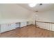 A spacious room with built in cabinets, access to the staircase, and wood floors at 3775 Belle Glade Trl, Snellville, GA 30039