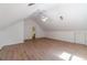 An open attic bonus room features a ceiling fan, white walls, and hardwood floors at 3775 Belle Glade Trl, Snellville, GA 30039