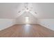 Spacious bonus room with vaulted ceiling, ceiling fan and light wood floors at 3775 Belle Glade Trl, Snellville, GA 30039