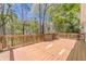 Expansive wood deck with wood railing overlooking the surrounding trees at 3775 Belle Glade Trl, Snellville, GA 30039