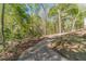 Long paved driveway leading to the house, surrounded by mature trees and landscaping at 3775 Belle Glade Trl, Snellville, GA 30039
