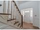 Bright entryway featuring hardwood floors, wainscotting, and a staircase with a white and wood railing at 3775 Belle Glade Trl, Snellville, GA 30039