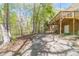 Rear exterior view showing a brick facade, wooden deck, and a long driveway for parking at 3775 Belle Glade Trl, Snellville, GA 30039