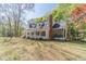 Side view of a charming home with a screened in porch, well-manicured lawn, and mature trees at 3775 Belle Glade Trl, Snellville, GA 30039
