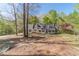 A quaint home with well maintained landscaping and a partial stone wall, nestled among mature trees at 3775 Belle Glade Trl, Snellville, GA 30039