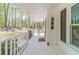 Inviting front porch with white railings, a stylish doormat, and views of the lush, wooded surroundings at 3775 Belle Glade Trl, Snellville, GA 30039