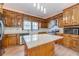 Updated kitchen features wood cabinetry, stainless appliances, stone countertops, white subway tile backsplash, and wood flooring at 3775 Belle Glade Trl, Snellville, GA 30039