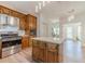 Charming kitchen featuring stainless appliances, shaker cabinets, stylish light fixtures, and stone countertops at 3775 Belle Glade Trl, Snellville, GA 30039