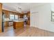Traditional kitchen with wooden cabinets, stainless steel appliances, a central island, and new floors at 3775 Belle Glade Trl, Snellville, GA 30039