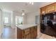 Kitchen with white countertops, wood cabinets, stainless steel refrigerator, and a center island with storage at 3775 Belle Glade Trl, Snellville, GA 30039