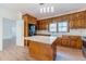 Traditional eat-in kitchen with wood cabinets, stainless steel appliances, and a center island with white countertops at 3775 Belle Glade Trl, Snellville, GA 30039