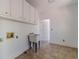 Laundry room with white walls, cabinets, and utilitarian sink at 3775 Belle Glade Trl, Snellville, GA 30039