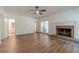 Open-concept living room with fireplace, hardwood floors and views to the backyard at 3775 Belle Glade Trl, Snellville, GA 30039