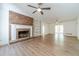 Open living room featuring a brick fireplace, built-in bookshelves and new vinyl flooring at 3775 Belle Glade Trl, Snellville, GA 30039