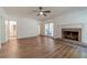 The hardwood floors stretch throughout an open living area that is anchored by a traditional fireplace at 3775 Belle Glade Trl, Snellville, GA 30039