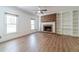 Spacious living room with a brick fireplace, built-in bookshelves, and large windows for ample natural light at 3775 Belle Glade Trl, Snellville, GA 30039