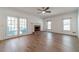 Bright living room featuring hardwood floors, a fireplace, and French doors leading to an outdoor space at 3775 Belle Glade Trl, Snellville, GA 30039