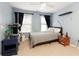 Standard bedroom with a bed, side tables and bright windows at 5075 Chase Ln, Cumming, GA 30040