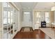 Bright foyer with hardwood floors and glass french doors, offering a welcoming entrance to the home at 5075 Chase Ln, Cumming, GA 30040