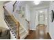 Elegant foyer featuring a staircase with wrought iron spindles and gleaming hardwood floors at 5075 Chase Ln, Cumming, GA 30040
