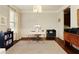 Versatile home office with warm hardwood floors and ample natural light for a productive workspace at 5075 Chase Ln, Cumming, GA 30040