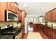 Kitchen with stainless steel appliances, granite countertops, and wood cabinets at 5075 Chase Ln, Cumming, GA 30040