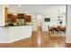 Open-concept kitchen and dining area with hardwood floors, stainless steel appliances, and ample natural light at 5075 Chase Ln, Cumming, GA 30040
