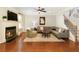 Cozy living room with hardwood floors, a fireplace, and comfortable seating, perfect for relaxing at 5075 Chase Ln, Cumming, GA 30040