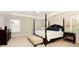 Main bedroom with a four-poster bed, bench seating and natural light at 5075 Chase Ln, Cumming, GA 30040