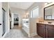 Bathroom featuring a soaking tub with tile surround, shower, and wood cabinets at 609 Eskimo Ct, Cts, Hampton, GA 30228