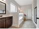 Bathroom featuring dark cabinets, a soaking tub, and a large framed mirror at 609 Eskimo Ct, Cts, Hampton, GA 30228