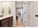 Bathroom vanity featuring warm wood cabinetry, white countertop and decoratively hung towels at 609 Eskimo Ct, Cts, Hampton, GA 30228