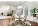 Bright breakfast nook features a glass-top table, decorative chairs, and sun-filled windows with a view at 609 Eskimo Ct, Cts, Hampton, GA 30228