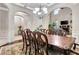 Spacious dining area boasts hardwood floors, decorative rug, and decorative chairs, filled with natural light at 609 Eskimo Ct, Cts, Hampton, GA 30228
