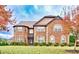 Traditional brick home with manicured lawn and mature trees showcasing curb appeal and classic design at 609 Eskimo Ct, Cts, Hampton, GA 30228