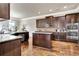Modern kitchen featuring granite countertops, stainless steel appliances, and rich wood cabinetry at 609 Eskimo Ct, Cts, Hampton, GA 30228