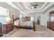 Main bedroom with tray ceiling, ceiling fan, and en suite bathroom at 609 Eskimo Ct, Cts, Hampton, GA 30228