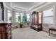 Bedroom with a sitting area, bright windows, and an armoire at 609 Eskimo Ct, Cts, Hampton, GA 30228