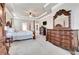 Spacious main bedroom with a trey ceiling, ceiling fan, and ornamental wood furniture at 609 Eskimo Ct, Cts, Hampton, GA 30228