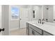 Bathroom with double sink vanity, modern fixtures, and a tiled shower at 683 Summitt Hill Way, Cumming, GA 30040