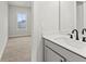 Bright bathroom featuring a modern sink with black fixtures and neutral paint at 683 Summitt Hill Way, Cumming, GA 30040