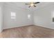 Spacious bedroom with tray ceiling, hardwood floors, and large windows for natural light at 683 Summitt Hill Way, Cumming, GA 30040