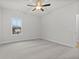 Bright and spacious bedroom with neutral carpet, white walls, ceiling fan, and a large window at 683 Summitt Hill Way, Cumming, GA 30040