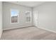 Neutral bedroom with carpet, white trim, and windows showing outside views at 683 Summitt Hill Way, Cumming, GA 30040