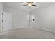 Bright and spacious bedroom with neutral carpet, white walls, ceiling fan, and two doors at 683 Summitt Hill Way, Cumming, GA 30040