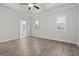 Spacious bedroom with tray ceiling, hardwood floors, and large windows for natural light at 683 Summitt Hill Way, Cumming, GA 30040